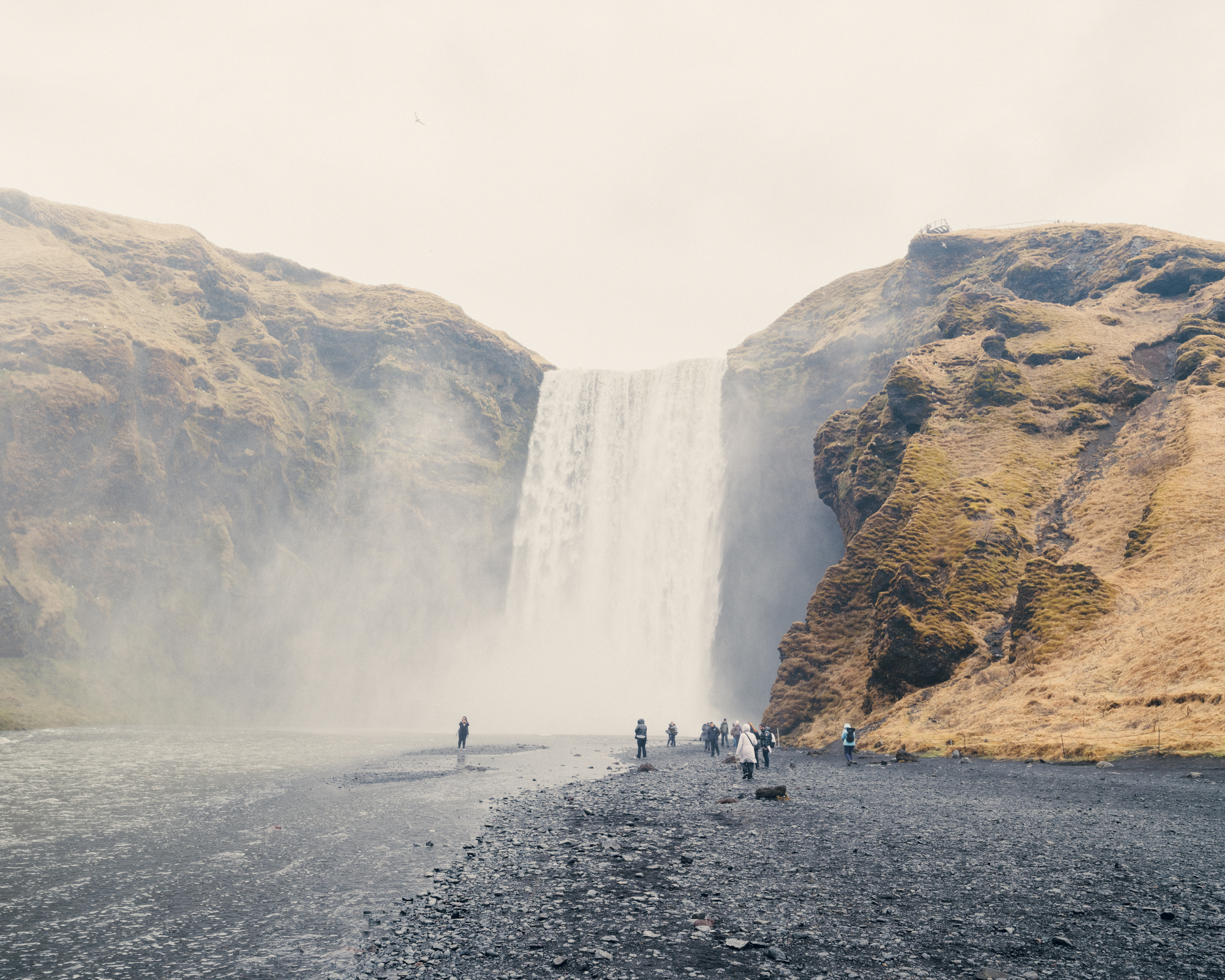 Crowded Skógafoss Waterfall: Popular attraction teeming with visitors in Iceland