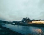 shows a geothermally heated greenhouse, typical of Icelandic agricultural operations, particularly in the Hveragerði region or near the geothermal fields in the southern part of the country.