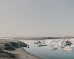 The floating icebergs and adjacent bridge in the background are characteristic of this site, ökulsárlón Glacier Lagoon, one of Iceland’s most iconic glacial lagoons. Located in southeastern Iceland. 